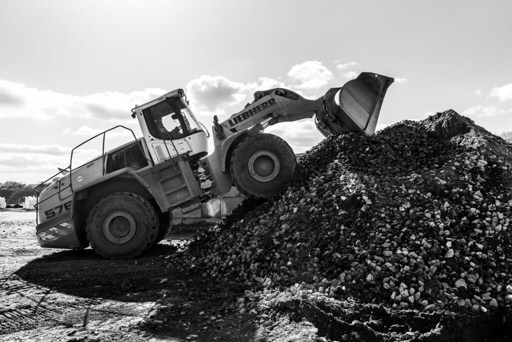 Digger on a pile of stone at Hereford Quarries