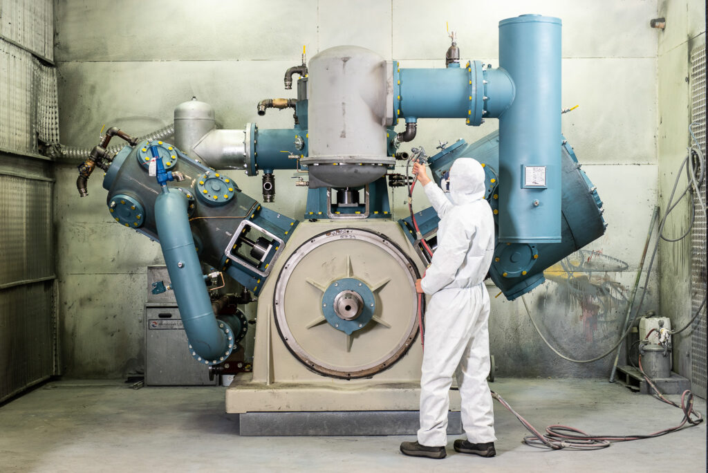 Industrial Photography of a man working on an industrial compressor in a factory near Birmingham