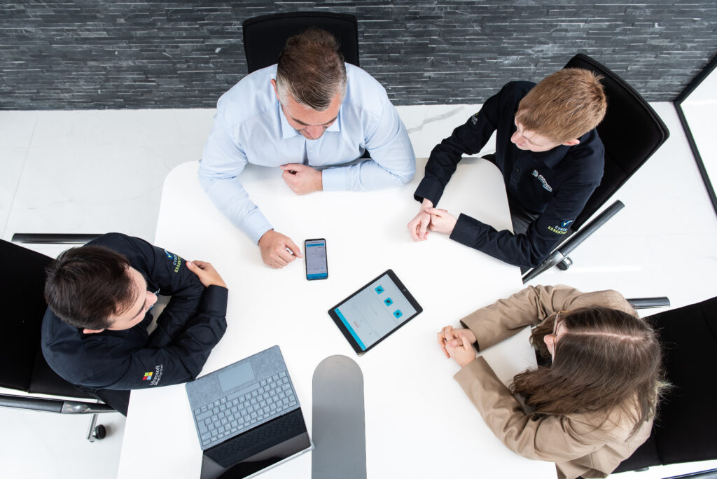 Industrial photography of a boardroom meeting taking place, photographed overhead
