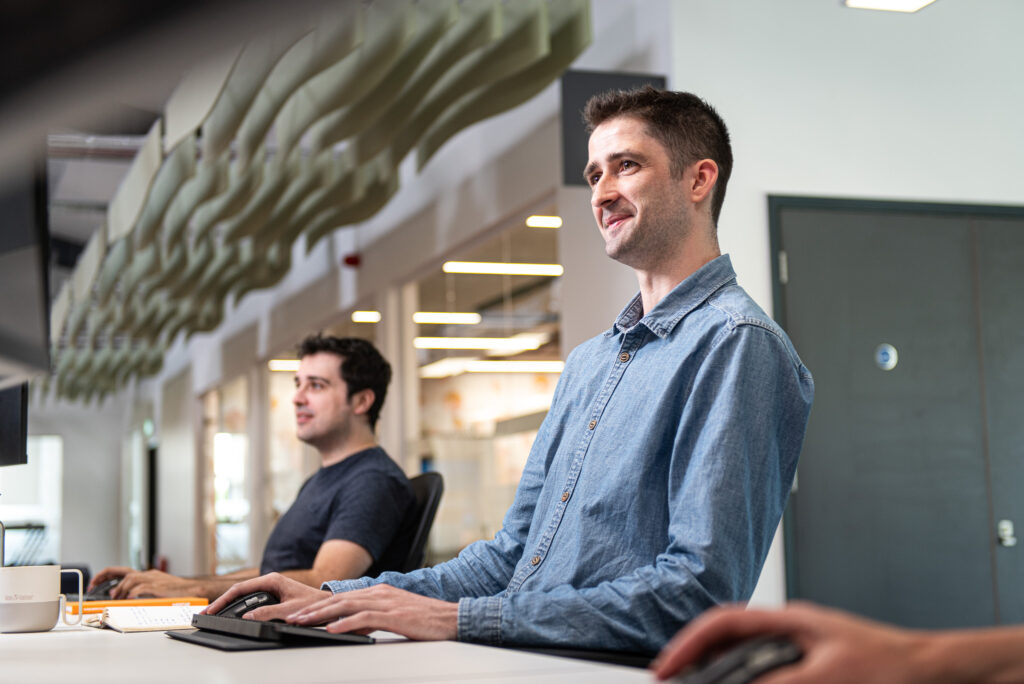 Industrial Photography of a man wearing a blue shirt in an office working on a computer